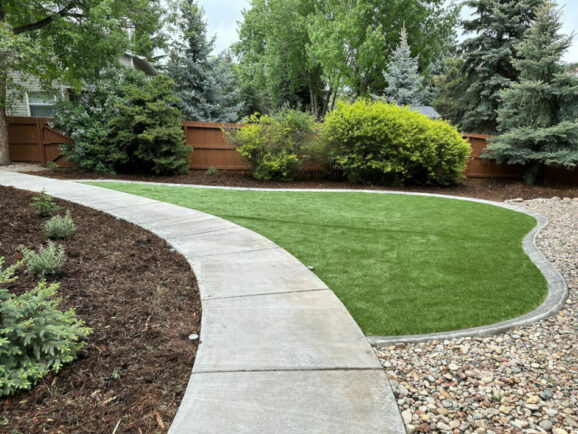 nice lawn scape with rock and brown mulch